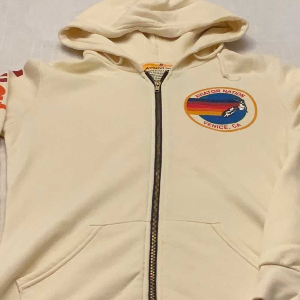 Used Aviator Nation Cream Hoodie size M. Two front pockets, front zipper